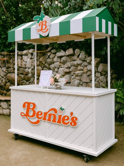The Bernie&rsquo;s Italian ice cart with its green-and-white striped awning and orange Bernie&rsquo;s sign